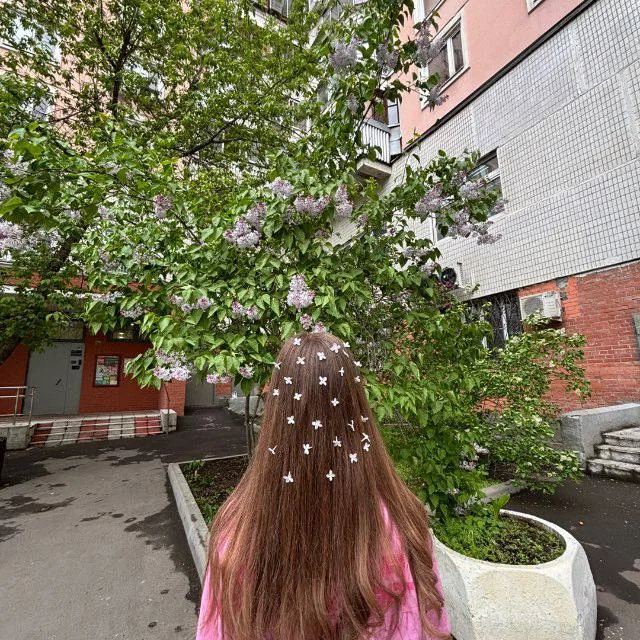 Таня со звездочками в волосах под цветущей сиренью